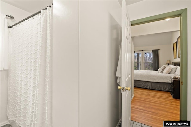 ensuite bathroom with curtained shower and ensuite bathroom