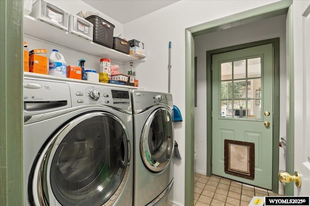 clothes washing area with baseboards, light tile patterned flooring, laundry area, and independent washer and dryer