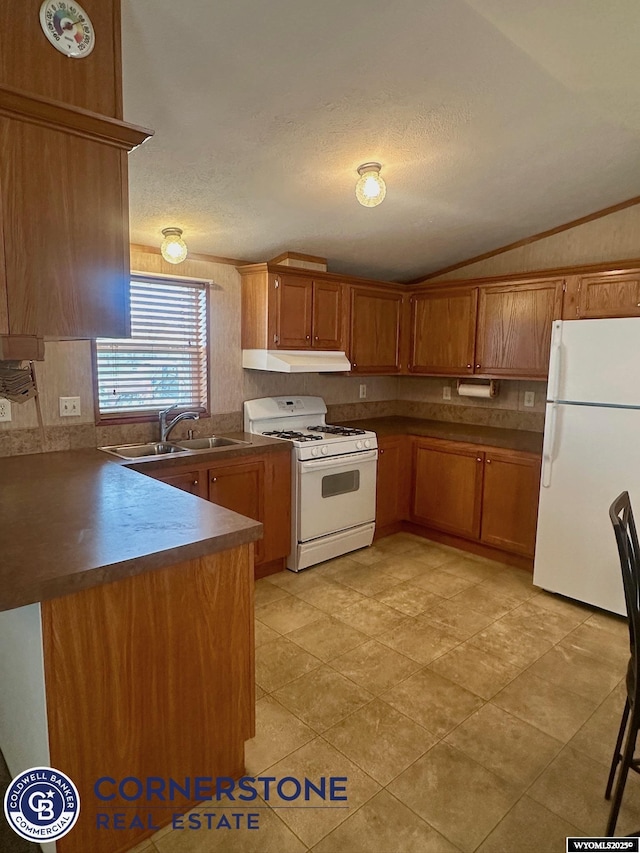 kitchen with brown cabinets, a sink, a peninsula, white appliances, and lofted ceiling