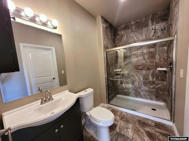 full bath with baseboards, a stall shower, toilet, and vanity