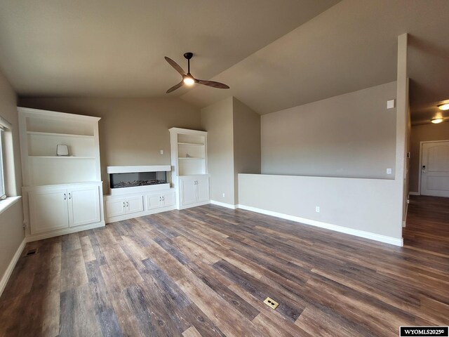 unfurnished living room featuring a ceiling fan, built in features, wood finished floors, and lofted ceiling