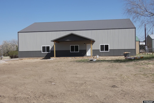 back of house featuring an outdoor structure and an outbuilding