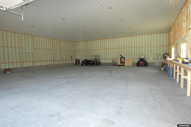 misc room with concrete floors and a garage