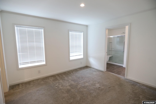 unfurnished bedroom featuring baseboards and carpet