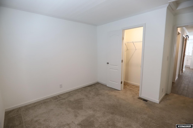 carpeted empty room with baseboards and visible vents