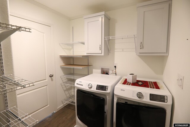 laundry area featuring cabinet space, independent washer and dryer, and dark wood-style flooring
