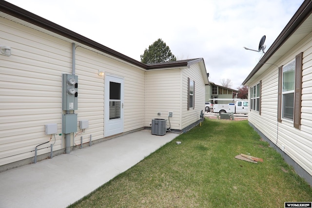 view of yard featuring central AC unit and a patio