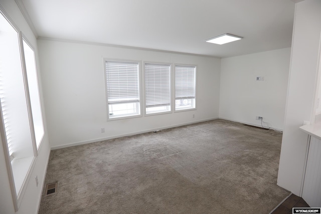 unfurnished room featuring carpet flooring, baseboards, and visible vents