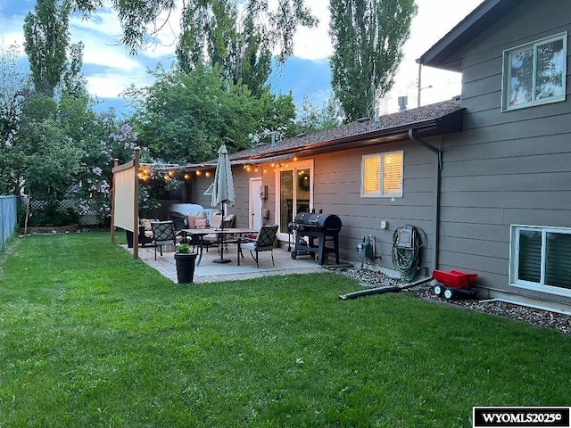 exterior space with a lawn, a patio, and fence
