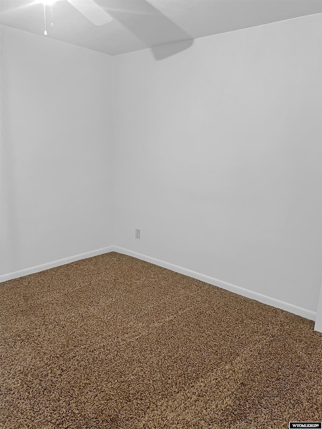 336 Emerson Ave, Evanston, WY 82930 - unfurnished room with baseboards, ceiling fan, and carpet flooring