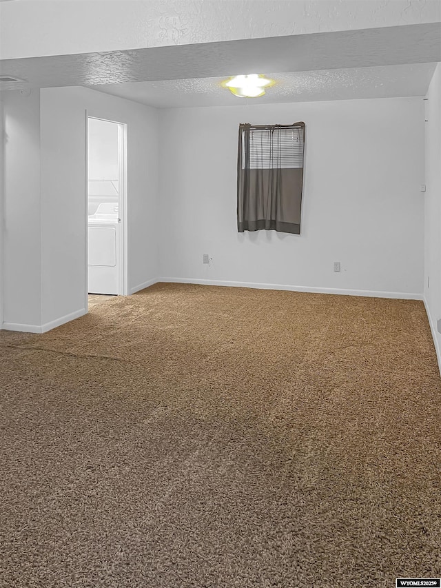 336 Emerson Ave, Evanston, WY 82930 - carpeted empty room with a textured ceiling, washer / dryer, and baseboards