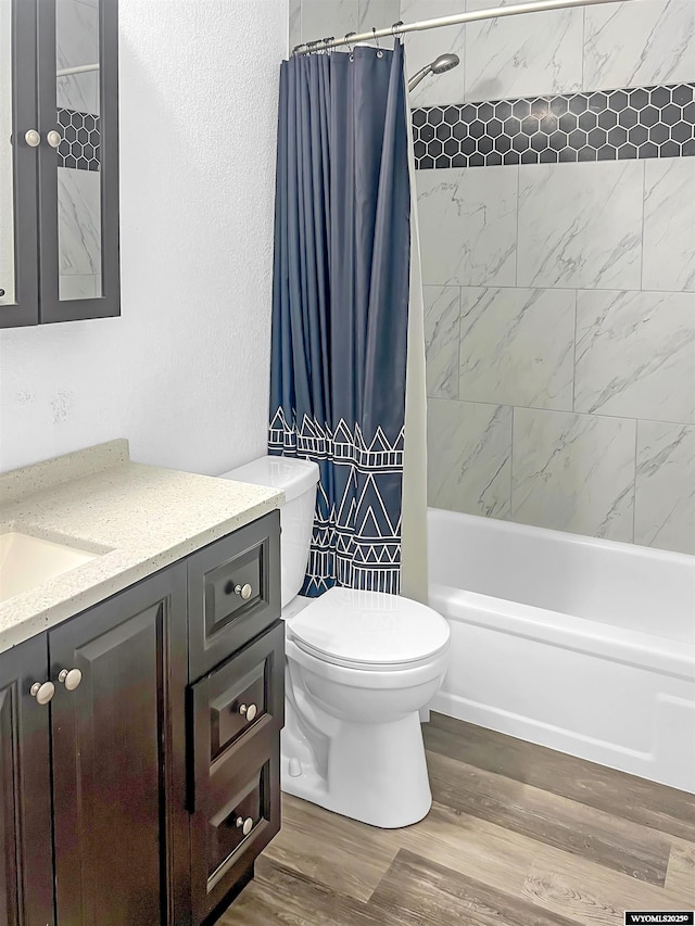 336 Emerson Ave, Evanston, WY 82930 - bathroom featuring vanity, toilet, wood finished floors, and shower / tub combo