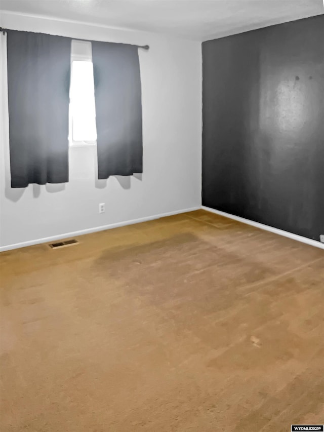 336 Emerson Ave, Evanston, WY 82930 - carpeted spare room featuring baseboards and visible vents