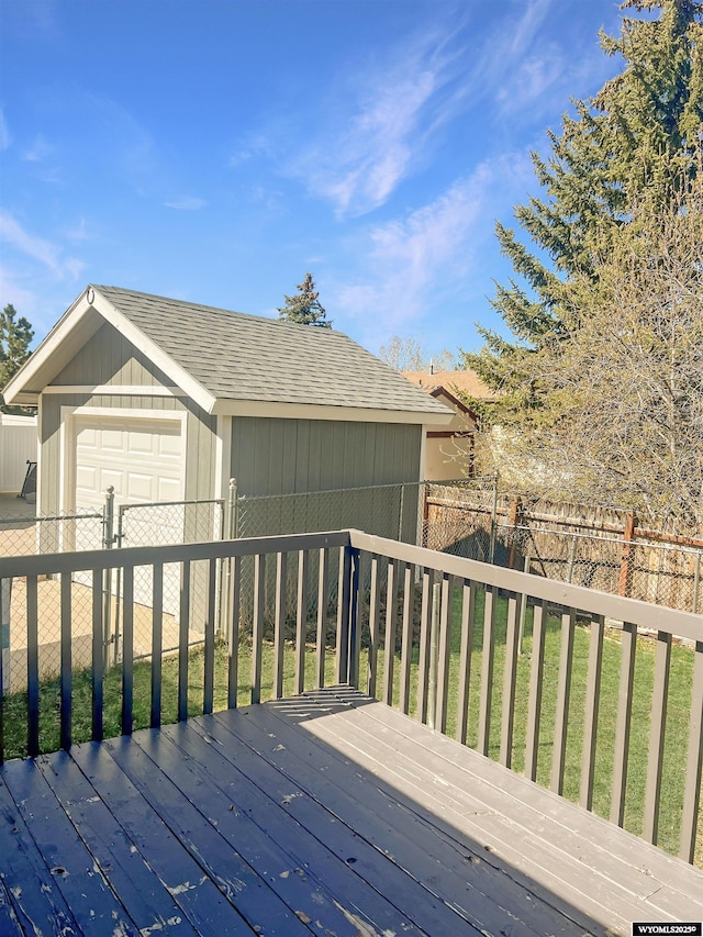 336 Emerson Ave, Evanston, WY 82930 - wooden deck featuring a detached garage, fence, and an outdoor structure