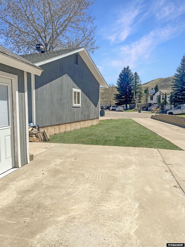 336 Emerson Ave, Evanston, WY 82930 - exterior space featuring a mountain view, a yard, and a patio area
