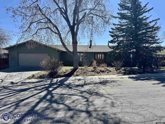 ranch-style house featuring an attached garage and driveway