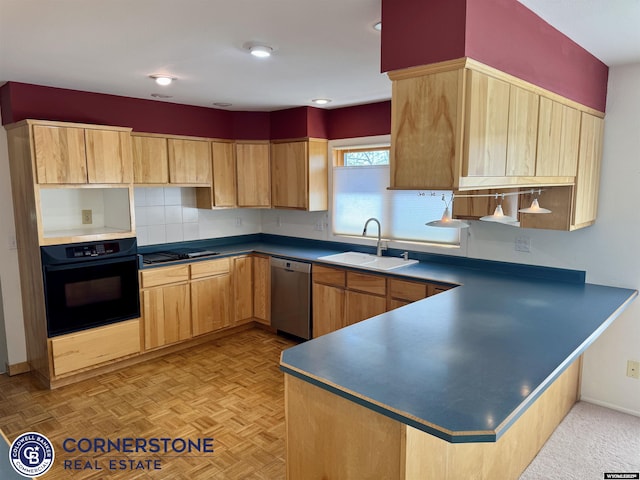 kitchen with dark countertops, light brown cabinetry, a sink, black appliances, and a peninsula