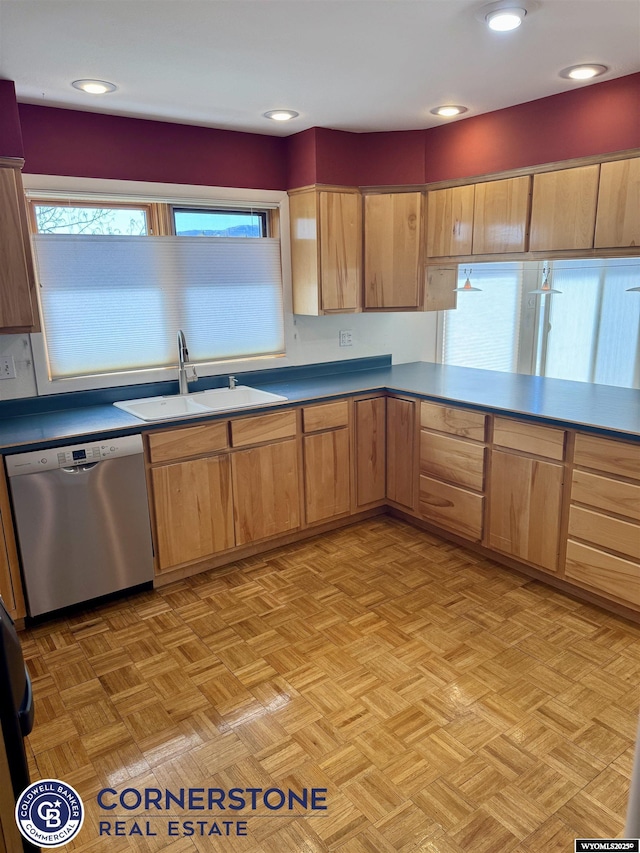 kitchen featuring dark countertops, a sink, and dishwasher