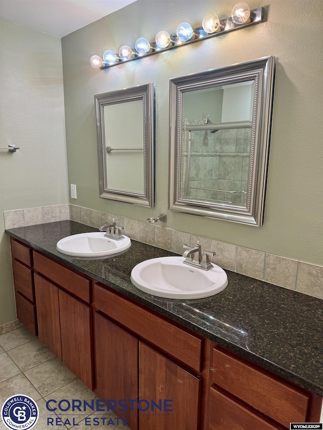 bathroom with double vanity, a sink, and tile patterned floors