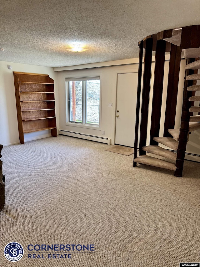 unfurnished living room featuring stairway, a textured ceiling, baseboard heating, and carpet