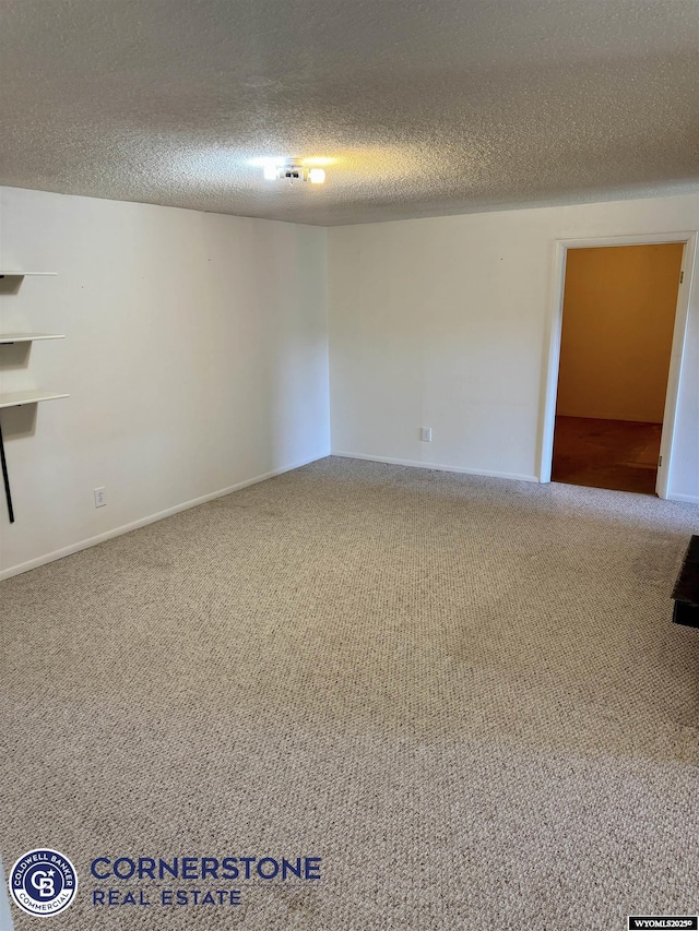 carpeted spare room with a textured ceiling