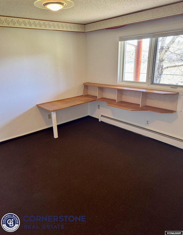 misc room featuring a textured ceiling, baseboard heating, and dark colored carpet