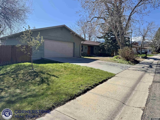 view of front of house with concrete driveway, an attached garage, fence, and a front lawn