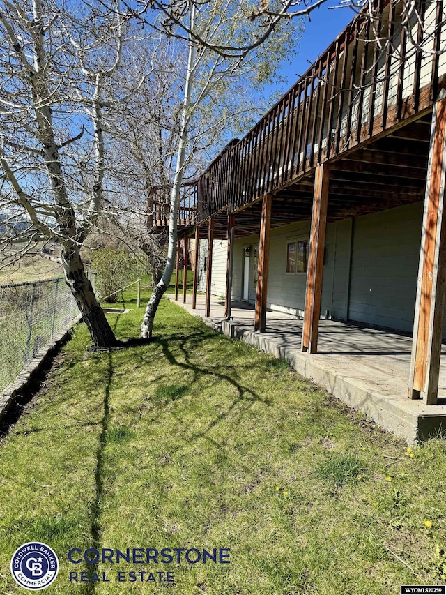 view of yard featuring a wooden deck and a patio area