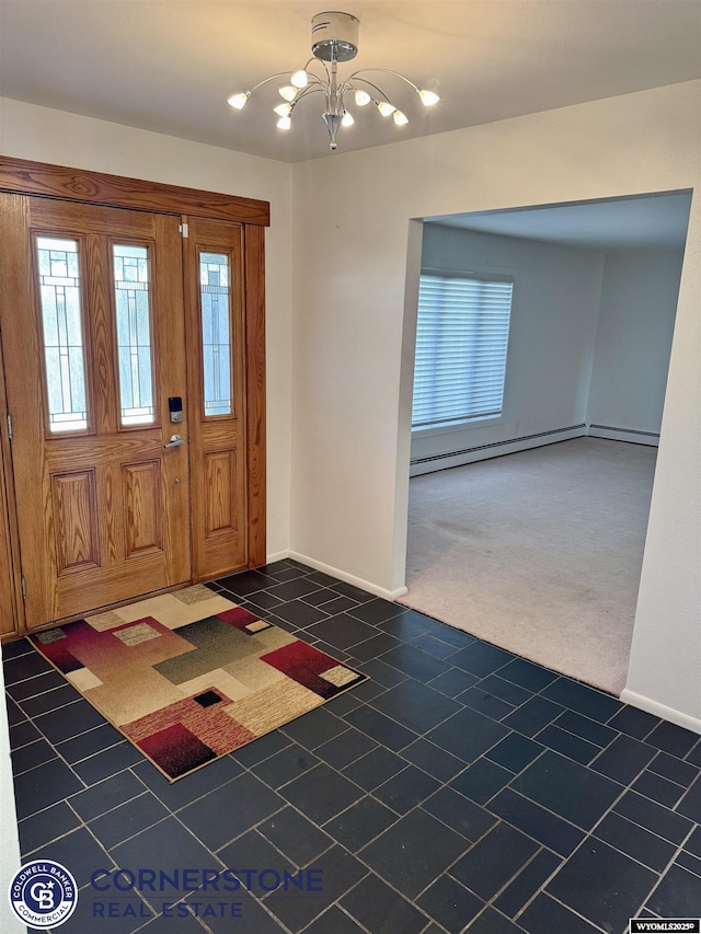 tiled foyer featuring baseboards and a notable chandelier