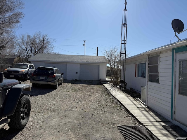 view of property exterior featuring a garage and an outdoor structure