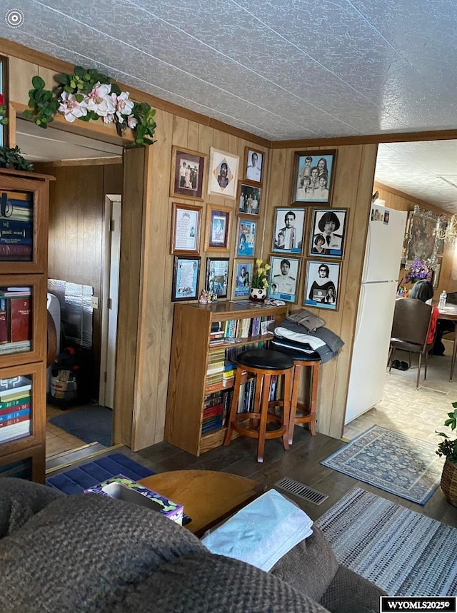 interior space with wooden walls and visible vents