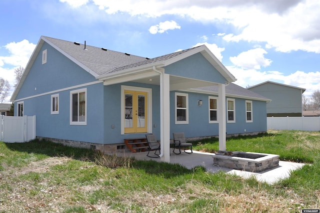 back of property with a patio, fence, a shingled roof, and entry steps