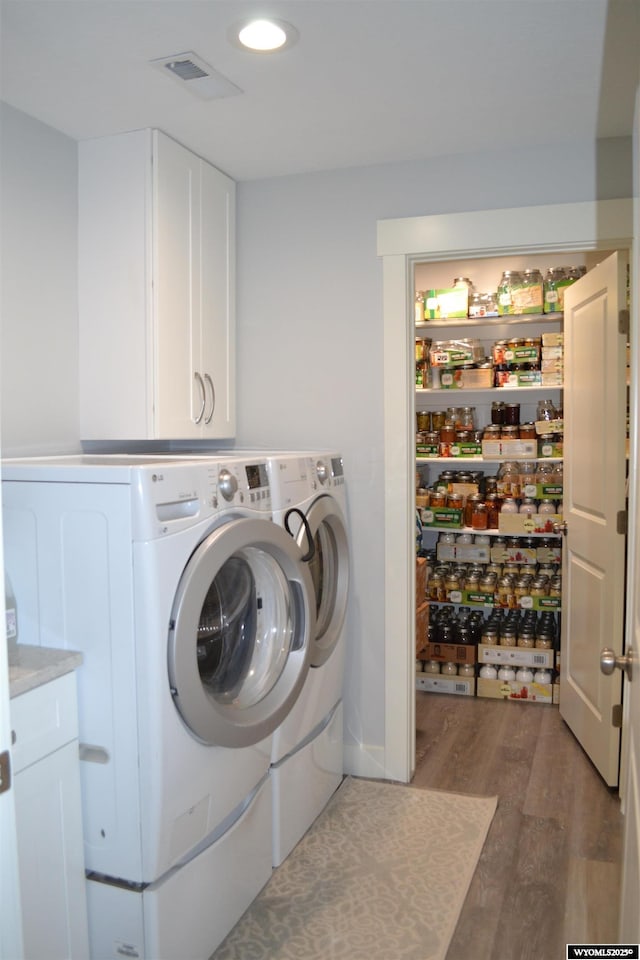 laundry room featuring visible vents, washing machine and dryer, recessed lighting, cabinet space, and light wood finished floors