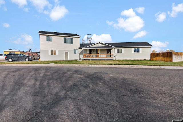 view of front of property with fence and covered porch