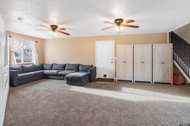 carpeted living room featuring a ceiling fan