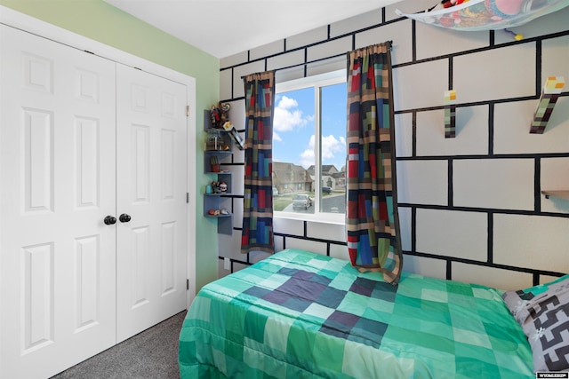 bedroom featuring a closet and carpet flooring