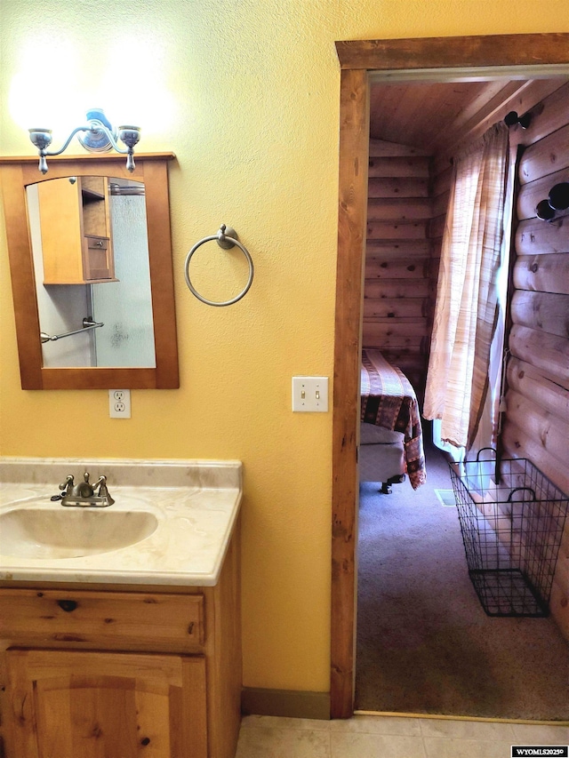 bathroom with vanity and rustic walls