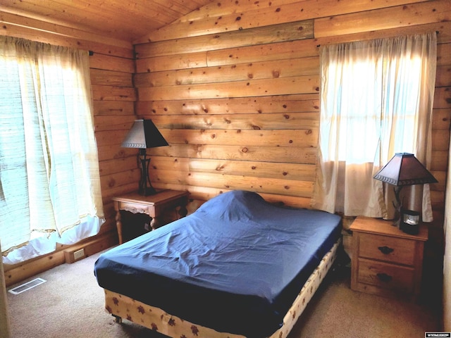 carpeted bedroom featuring wood ceiling, vaulted ceiling, and visible vents