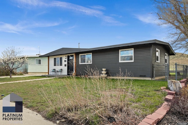 view of front of property with fence and a front lawn
