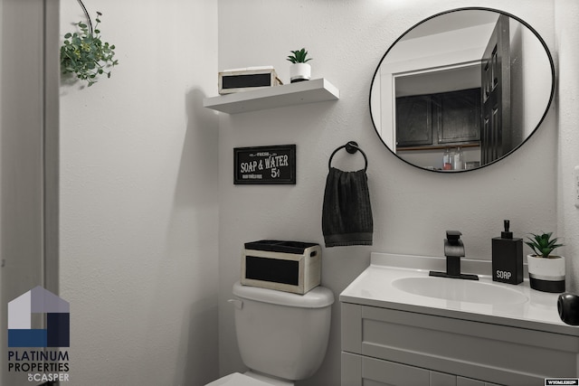 half bathroom with toilet and vanity