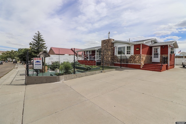 view of front facade featuring fence and stone siding