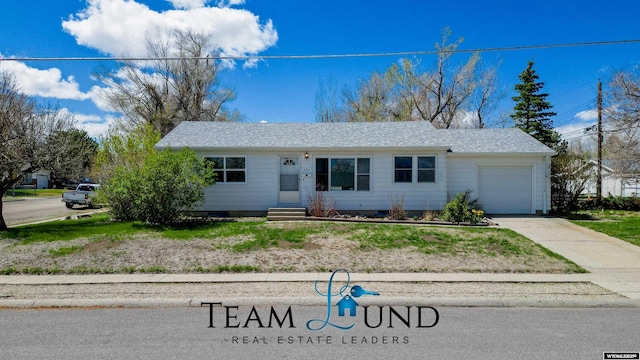 ranch-style home with an attached garage, a shingled roof, driveway, and entry steps