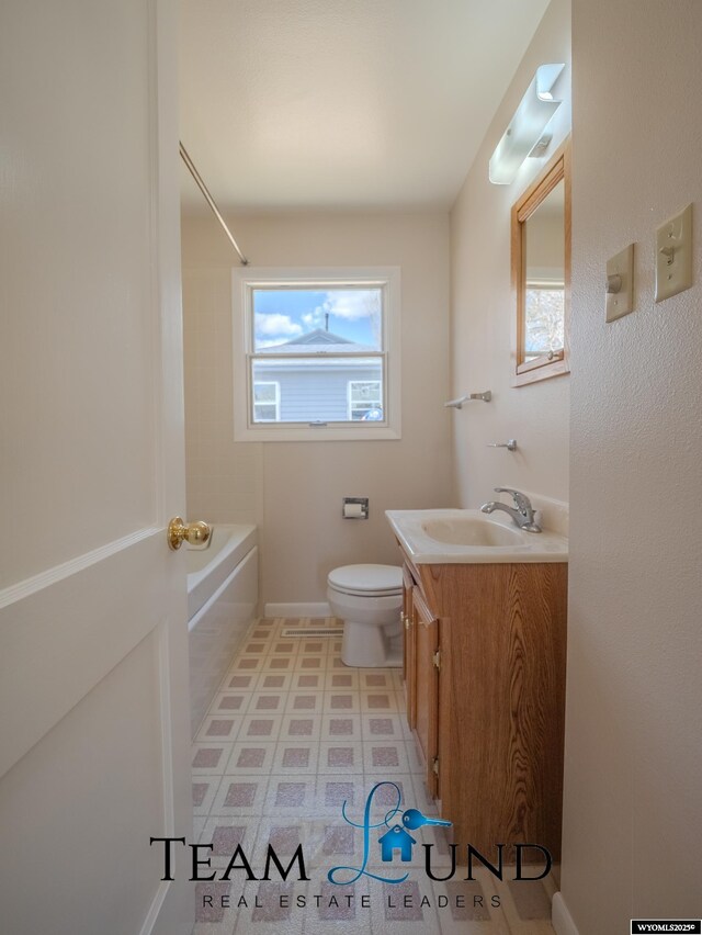 full bathroom with toilet, tile patterned floors, tub / shower combination, and vanity
