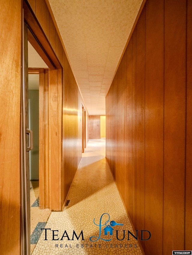 hall featuring wooden walls