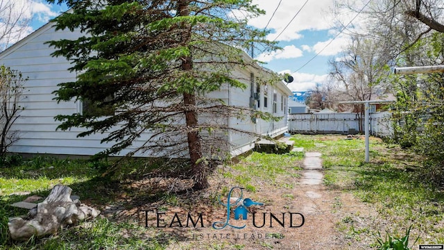 view of side of property with fence