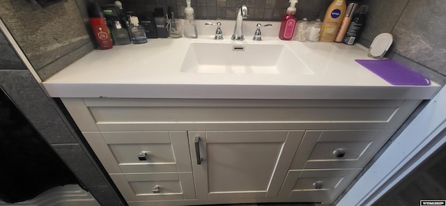 bathroom with decorative backsplash and vanity