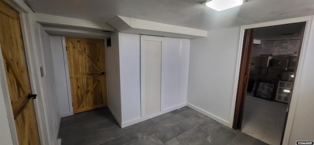 interior space featuring baseboards and a closet