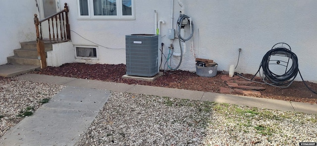 details featuring central AC and stucco siding