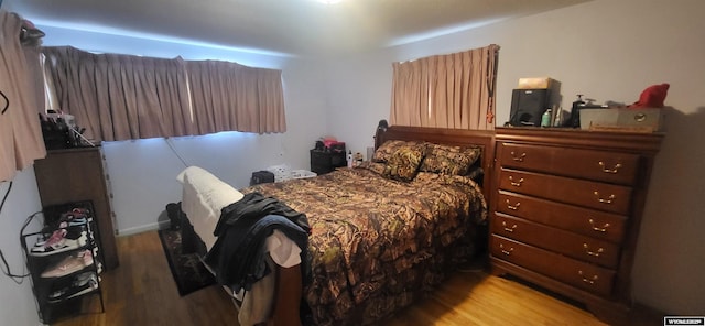 bedroom with wood finished floors