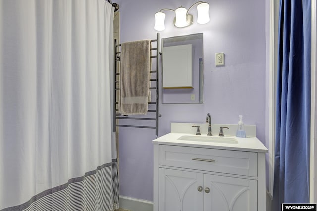 bathroom featuring a textured wall and vanity
